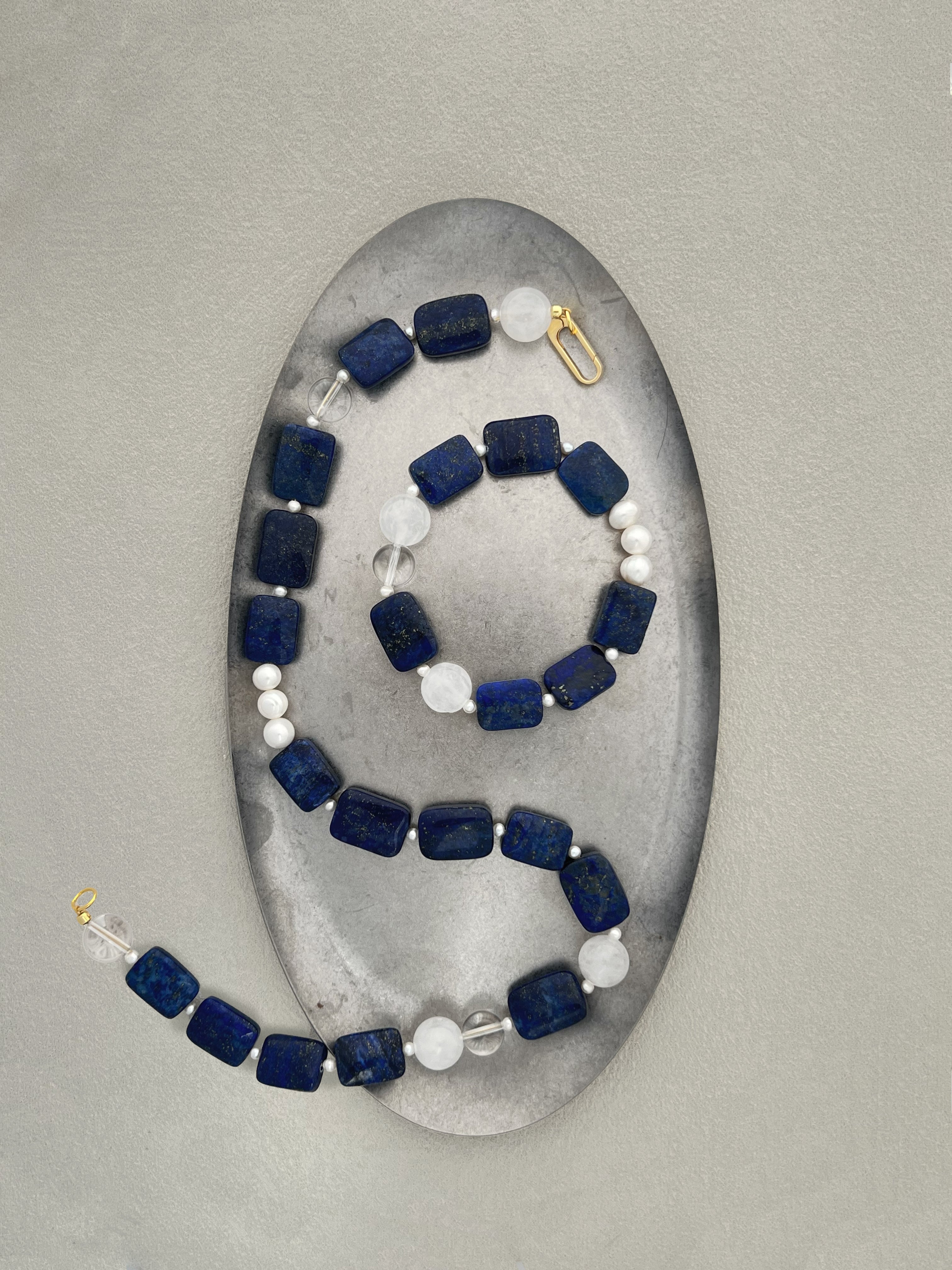 Amaré Qinghua collection main image showcasing "Wearable Porcelain" jewelry with Lapis Lazuli and White Jade gemstones on a minimalist background.