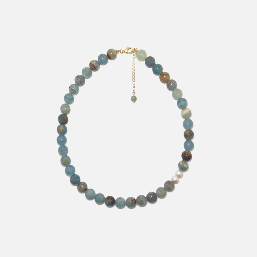 Handmade Blue Calcite crystal necklace with freshwater pearls on white background, soft blue tones and elegant design.