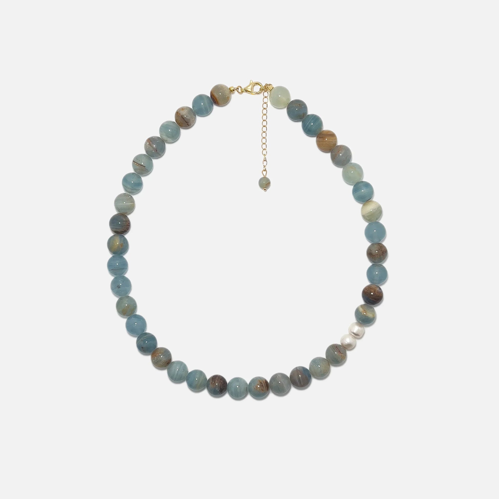 Handmade Blue Calcite crystal necklace with freshwater pearls on white background, soft blue tones and elegant design.