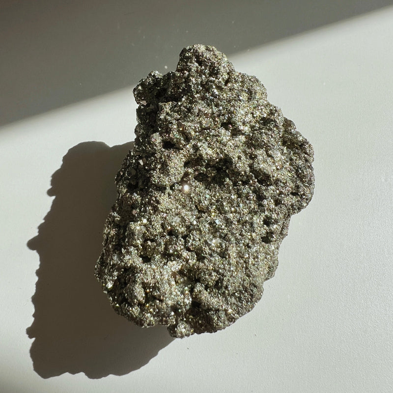 Hematite Raw Stone on a white surface with a gray background