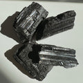 Four pieces of Black Tourmaline on a white background