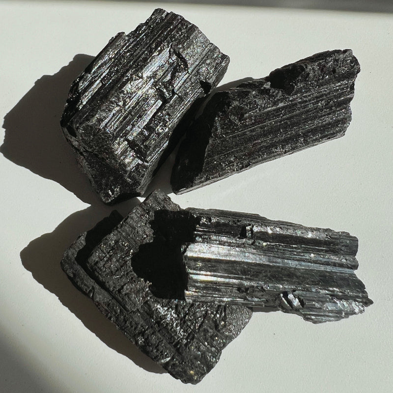 Four pieces of Black Tourmaline on a white background