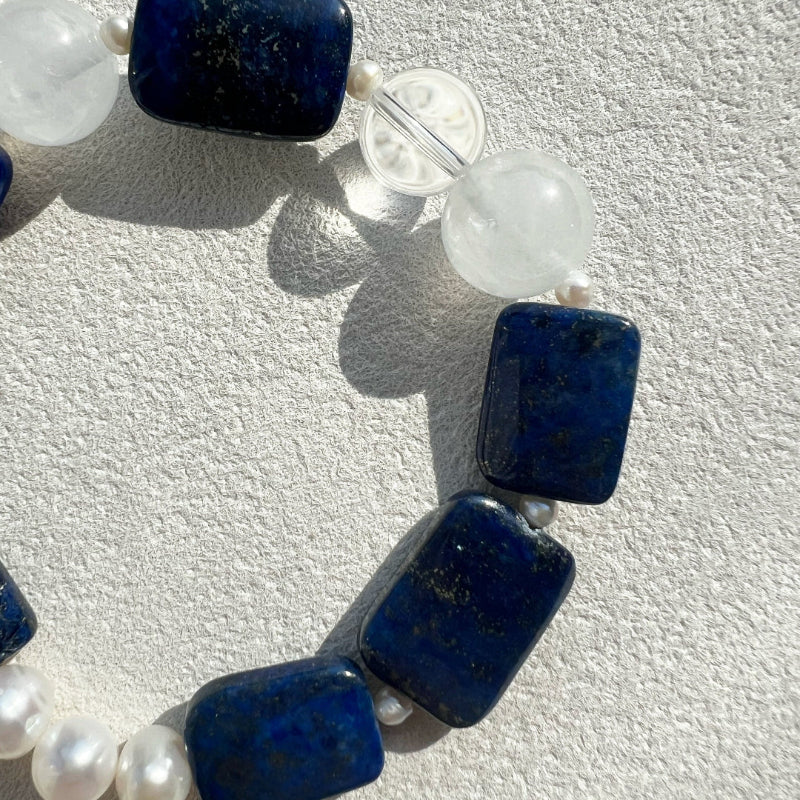 Close-up of the minimalist stretch design of the Qinghua bracelet, showcasing the seamless transition between high-grade gemstones without a metal clasp.