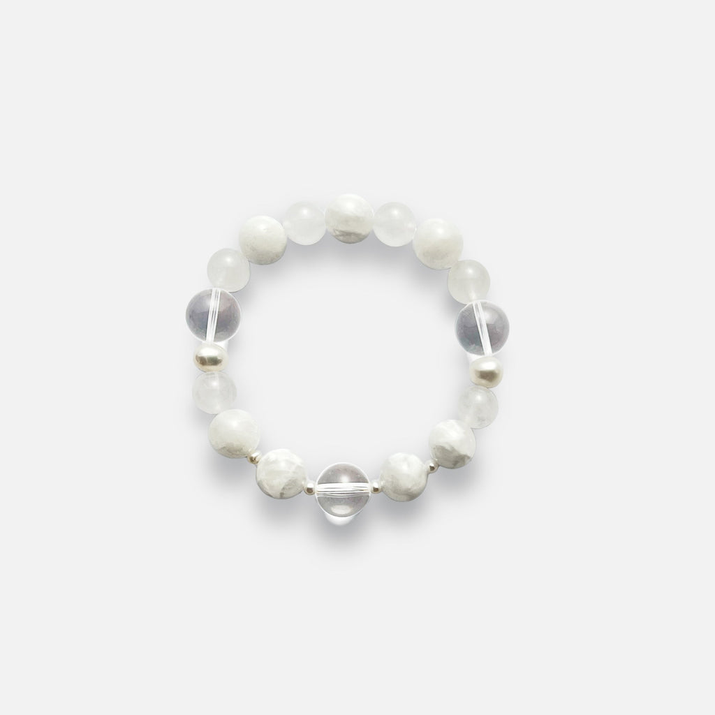 Amaré Qi stretch bracelet from the void & form collection, featuring 12mm clear quartz, 12mm white phantom quartz, 10mm white jade, and mixed-size pearls on a durable elastic cord.