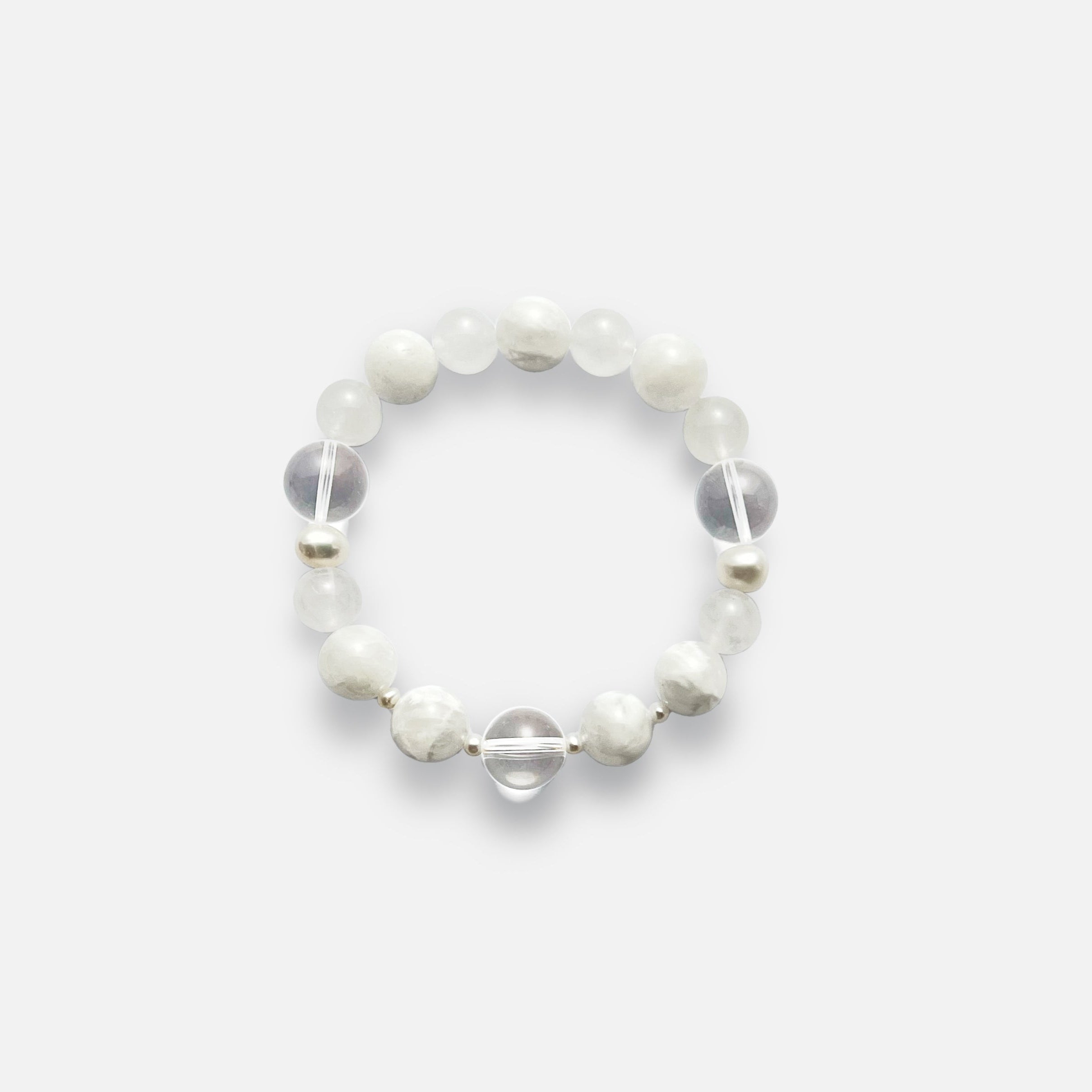 Amaré Qi stretch bracelet from the void & form collection, featuring 12mm clear quartz, 12mm white phantom quartz, 10mm white jade, and mixed-size pearls on a durable elastic cord.