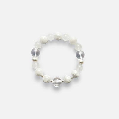 Amaré Qi stretch bracelet from the void & form collection, featuring 12mm clear quartz, 12mm white phantom quartz, 10mm white jade, and mixed-size pearls on a durable elastic cord.