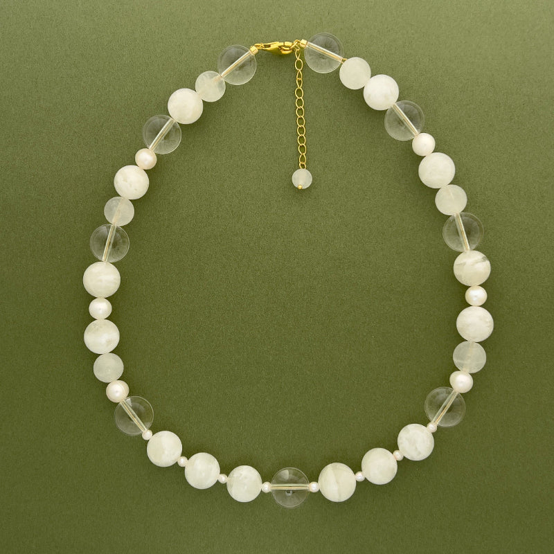 Elegant layout of the Amaré Qi necklace, highlighting the minimalist balance between crystalline textures and organic pearls within the void & form jewelry series.