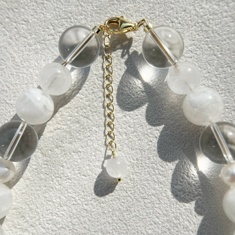 Detailed shot of the 18k gold-plated lobster clasp and extension chain with an S925 hallmark on the Qi necklace, ensuring luxury quality and security.