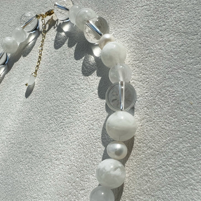 Close-up of the 10mm misty white jade and lustrous 8mm freshwater pearl, emphasizing the porcelain-like texture and handcrafted precision.