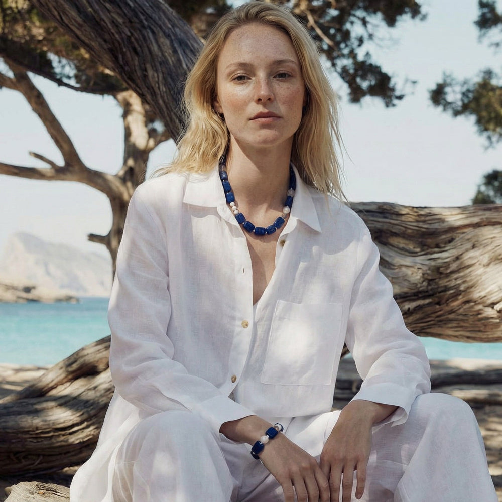 A model wearing the minimalist Amaré Qinghua elastic bracelet on the wrist, highlighting the comfortable fit and serenity of the void and form collection gemstones.