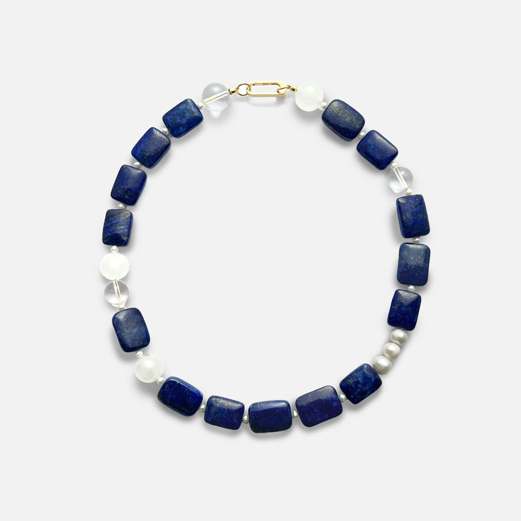 Amaré Qinghua Necklace featuring a misty white jade stone, deep blue lapis lazuli, and a lustrous freshwater pearl on an 18k gold chain, void and form collection, minimalist white background.