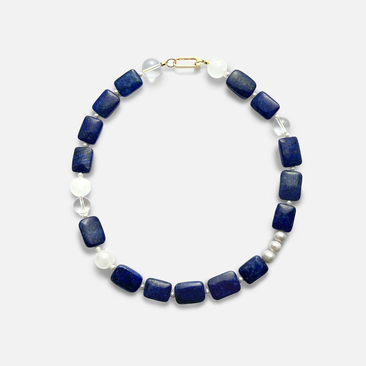 Amaré Qinghua Necklace featuring a misty white jade stone, deep blue lapis lazuli, and a lustrous freshwater pearl on an 18k gold chain, void and form collection, minimalist white background.