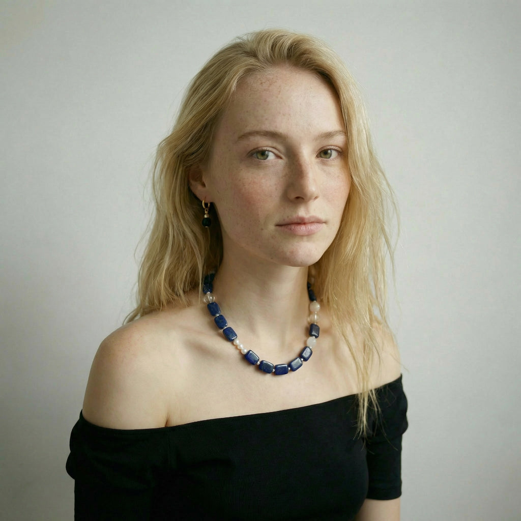 A model wearing the minimalist Amaré Qinghua necklace on the collarbone, showcasing the elegant drape and serenity of the void and form collection.