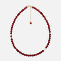 Red Agate crystal necklace with 6mm beads, freshwater pearls, and gold accents on a white background – handmade and stylish, perfect for daily grounding and confidence.