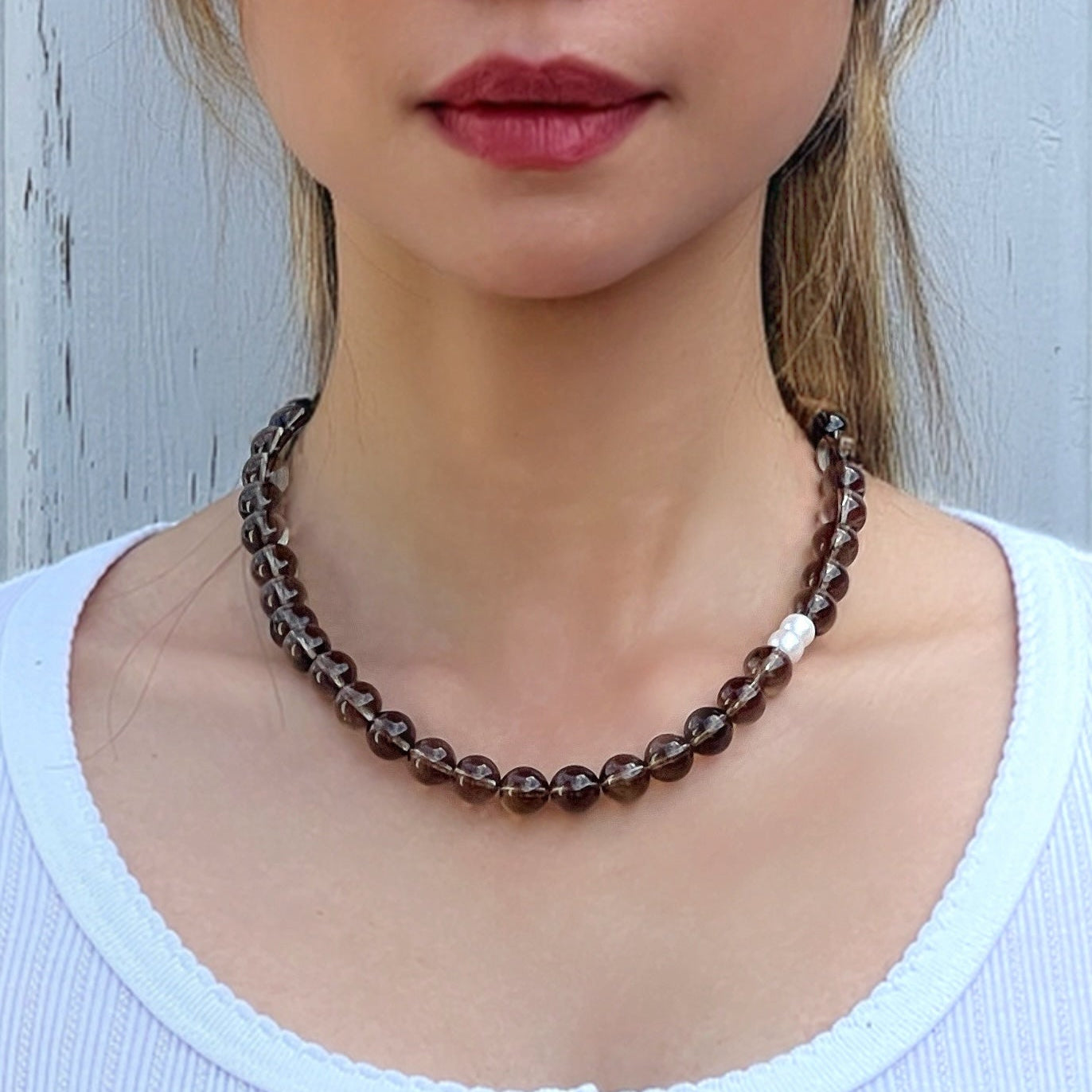 Model wearing handmade Smoky Quartz crystal necklace – grounding and protective jewelry with earthy elegance
