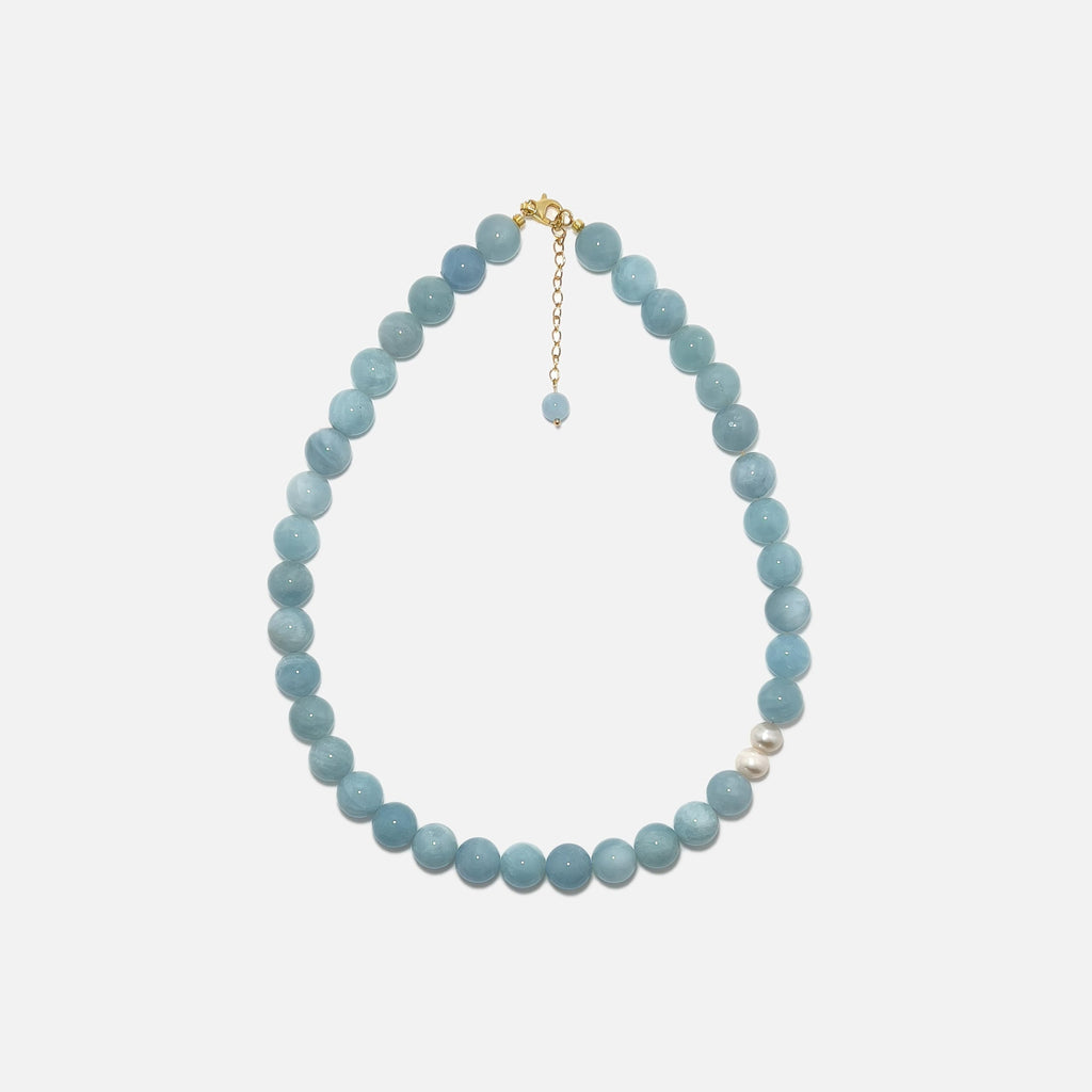 Handmade Aquamarine crystal necklace with freshwater pearls on white background, calming and elegant design.