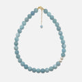 Handmade Aquamarine crystal necklace with freshwater pearls on white background, calming and elegant design.