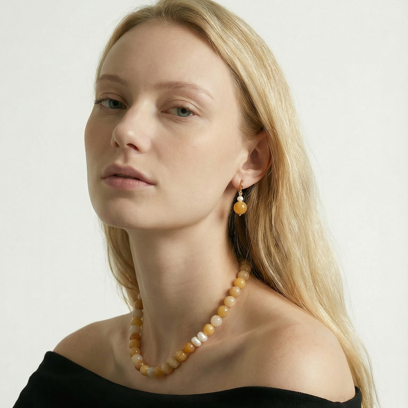 Woman wearing Amaré luz Yellow Aventurine Necklace and earrings