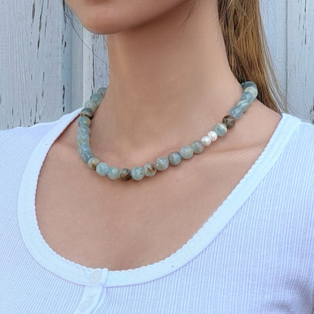 Model wearing handmade Blue Calcite crystal necklace – calming and soothing jewelry for clarity and emotional peace