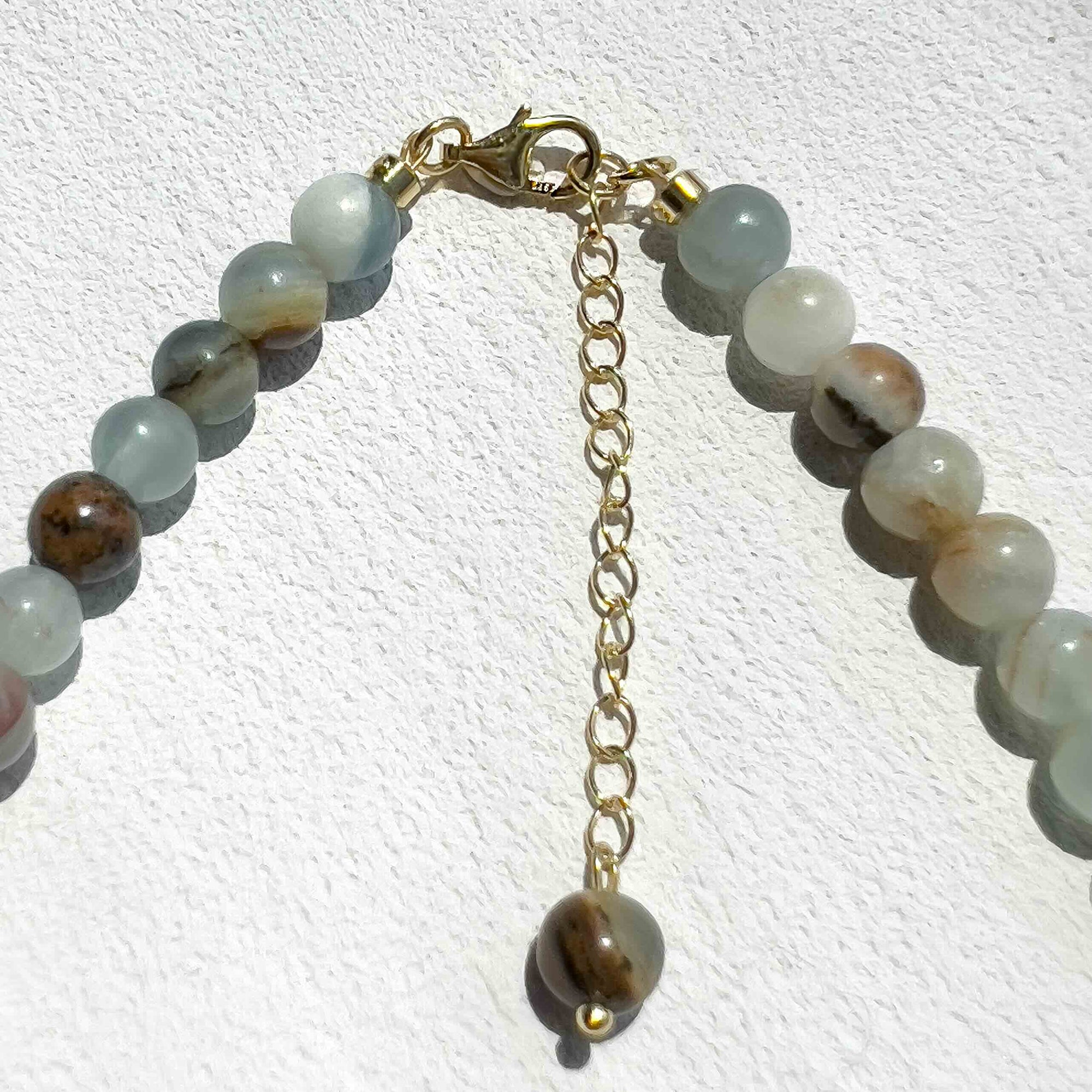 Close-up of the Blue Calcite Freya Necklace featuring 6mm pale blue calcite beads, subtle gold accents, and freshwater pearls, highlighting its calming energy and modern handmade design.
