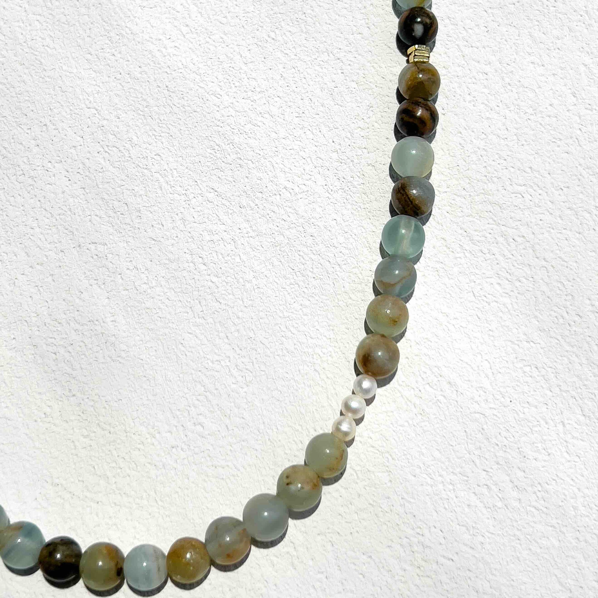 Close-up of the Blue Calcite Freya Necklace featuring 6mm pale blue calcite beads, subtle gold accents, and freshwater pearls, highlighting its calming energy and modern handmade design.