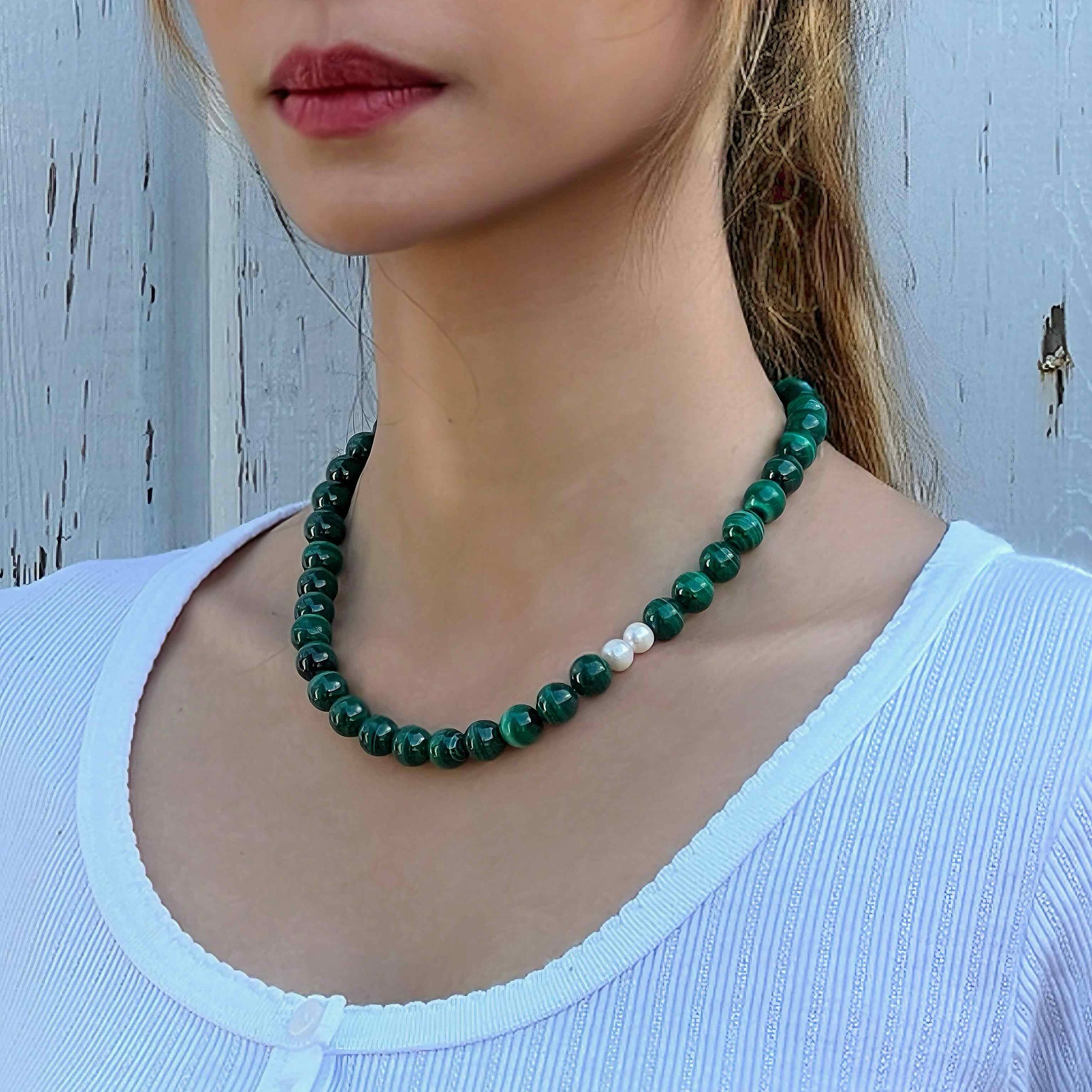 The model wearing Handmade Malachite crystal necklace with freshwater pearls – for transformation and protection