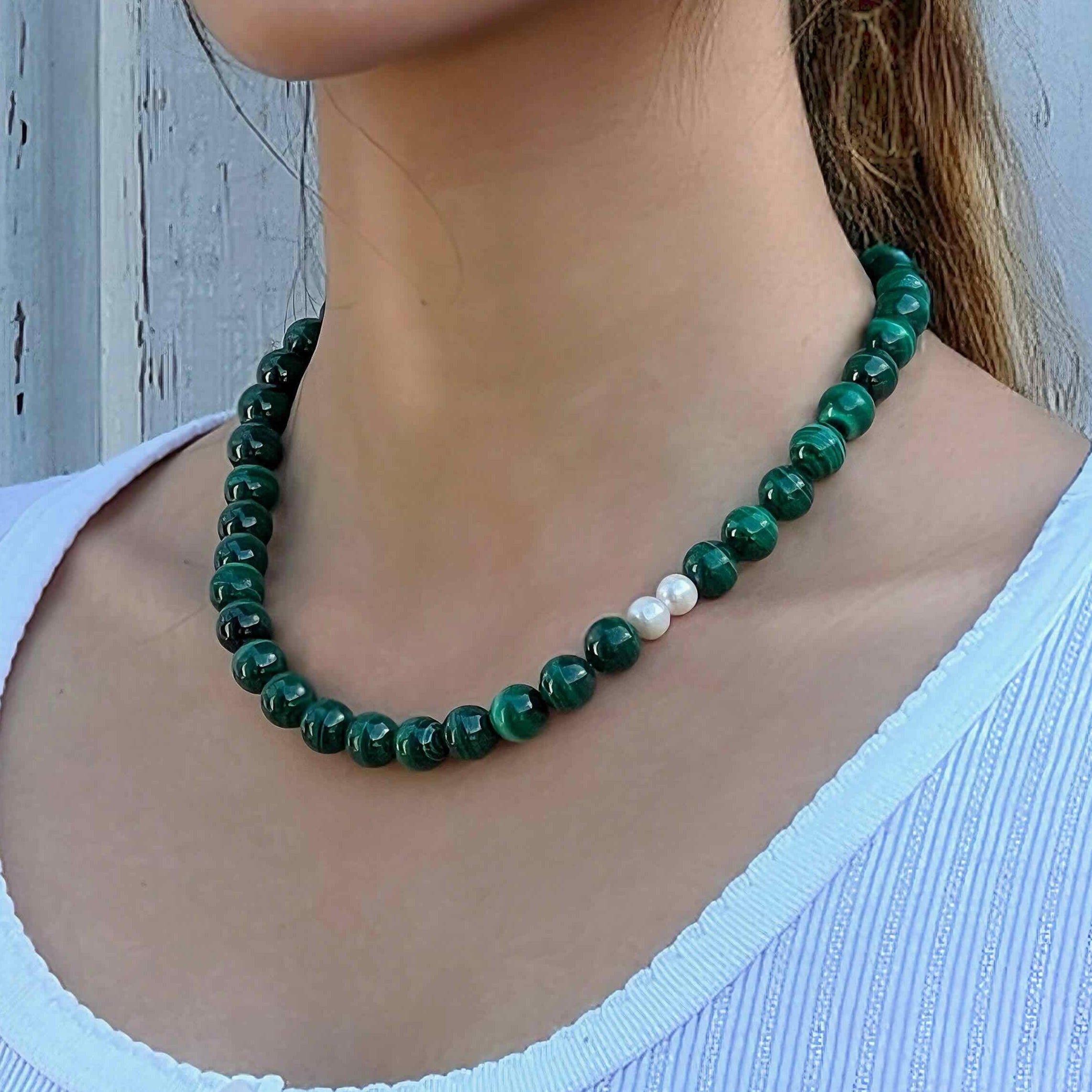 The model wearing Handmade Malachite crystal necklace with freshwater pearls – for transformation and protection