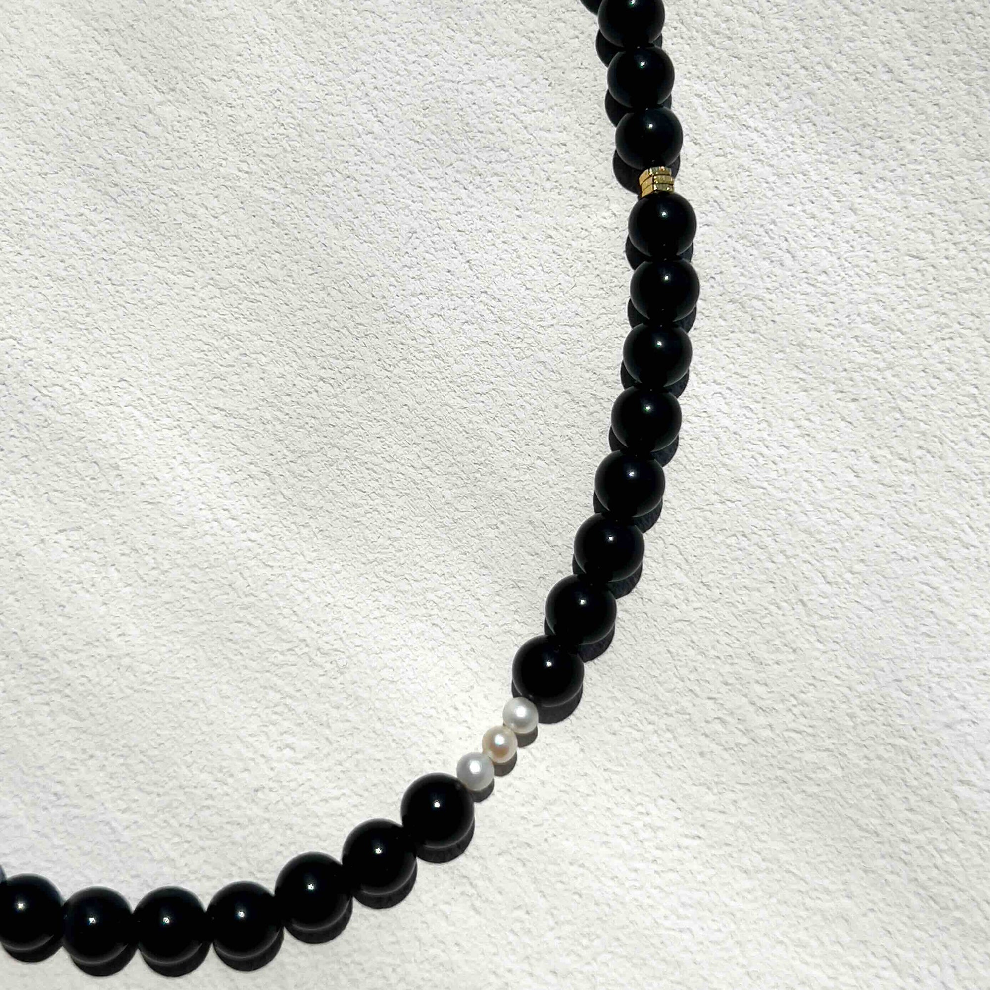 Close-up of the Obsidian Freya Necklace with smooth 6mm black obsidian beads, gold accents, and freshwater pearls, showcasing its grounding energy and elegant handmade design.