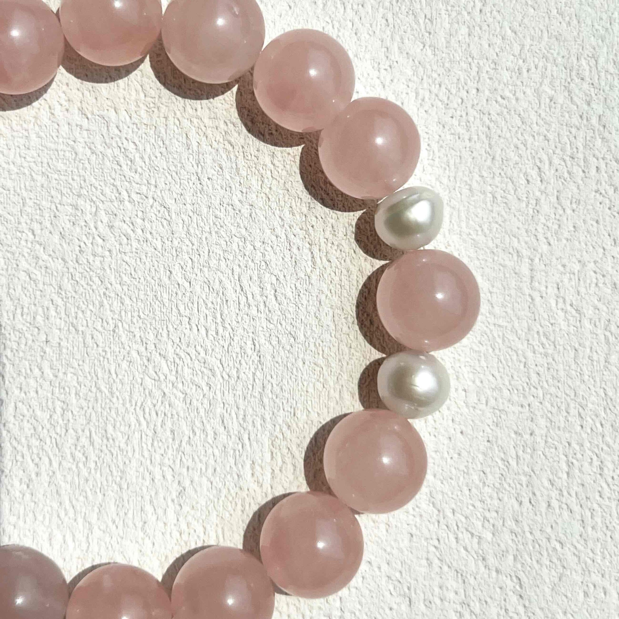 Close-up of Rose Quartz Bracelet featuring soft pink crystal beads and freshwater pearls, showcasing its gentle, loving energy and delicate handcrafted design.