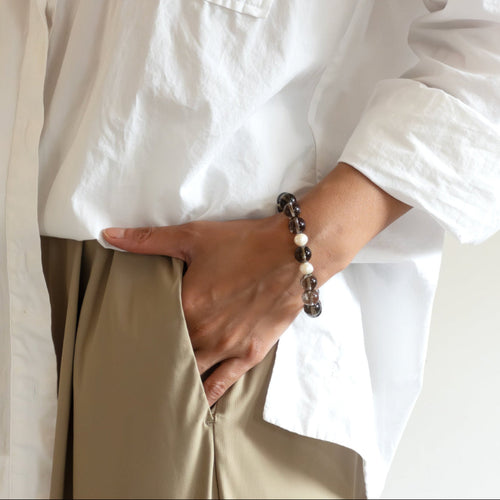 Model wearing Smoky Quartz crystal bracelet – handmade jewelry for grounding and emotional clarity
