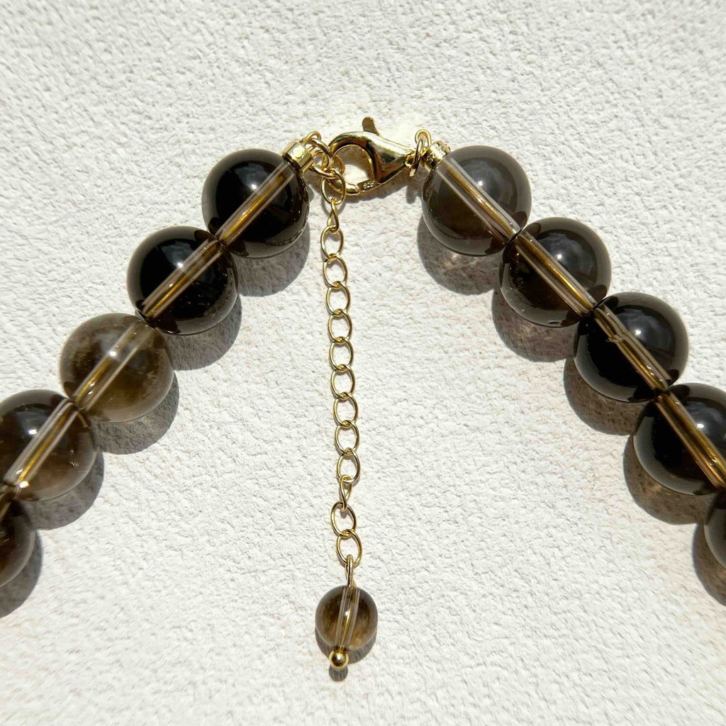 Close-up of Smoky Quartz Necklace showing natural smoky brown crystal beads with gold accents and freshwater pearls, highlighting the grounding and protective energy in a refined, handcrafted design.