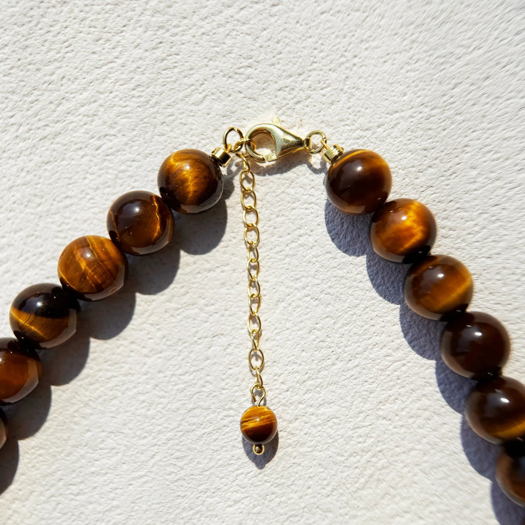 Close-up of Tiger’s Eye pendant and beads for grounding and strength