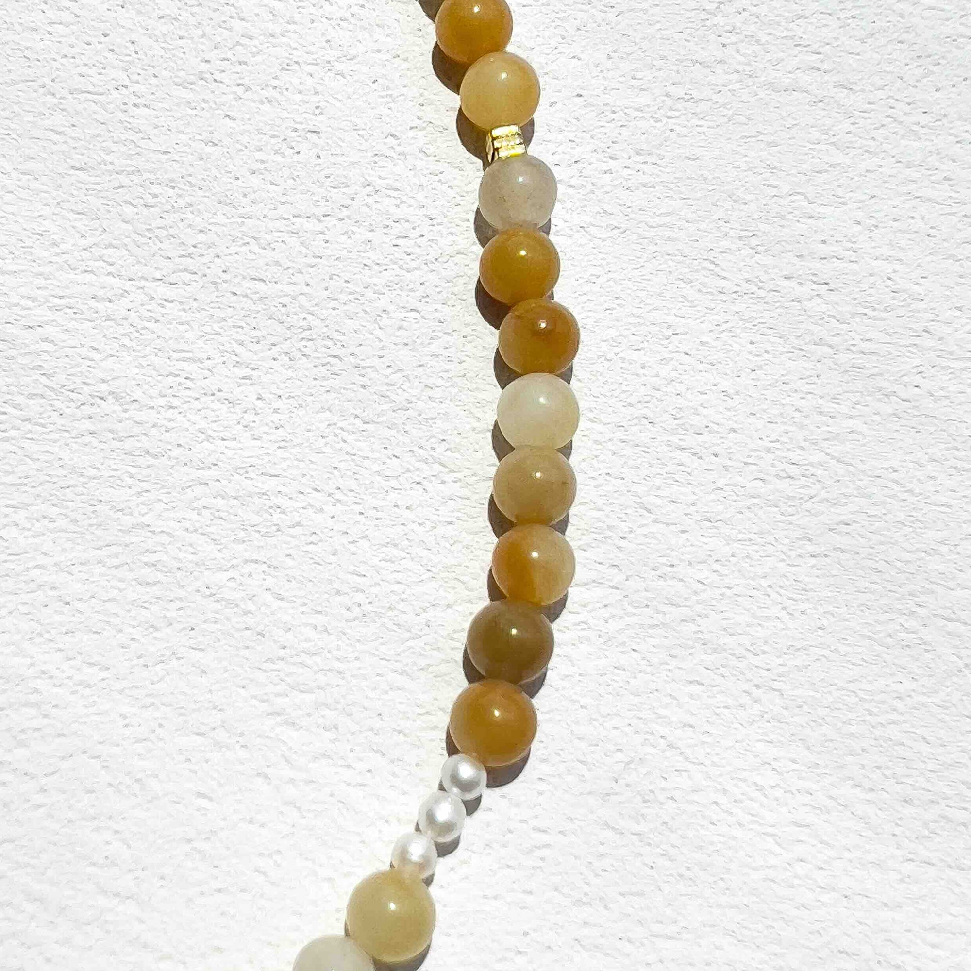 Close-up of the Yellow Aventurine Freya Necklace featuring soft yellow 6mm gemstone beads, subtle gold accents, and freshwater pearls, highlighting its warm, uplifting energy and delicate craftsmanship.