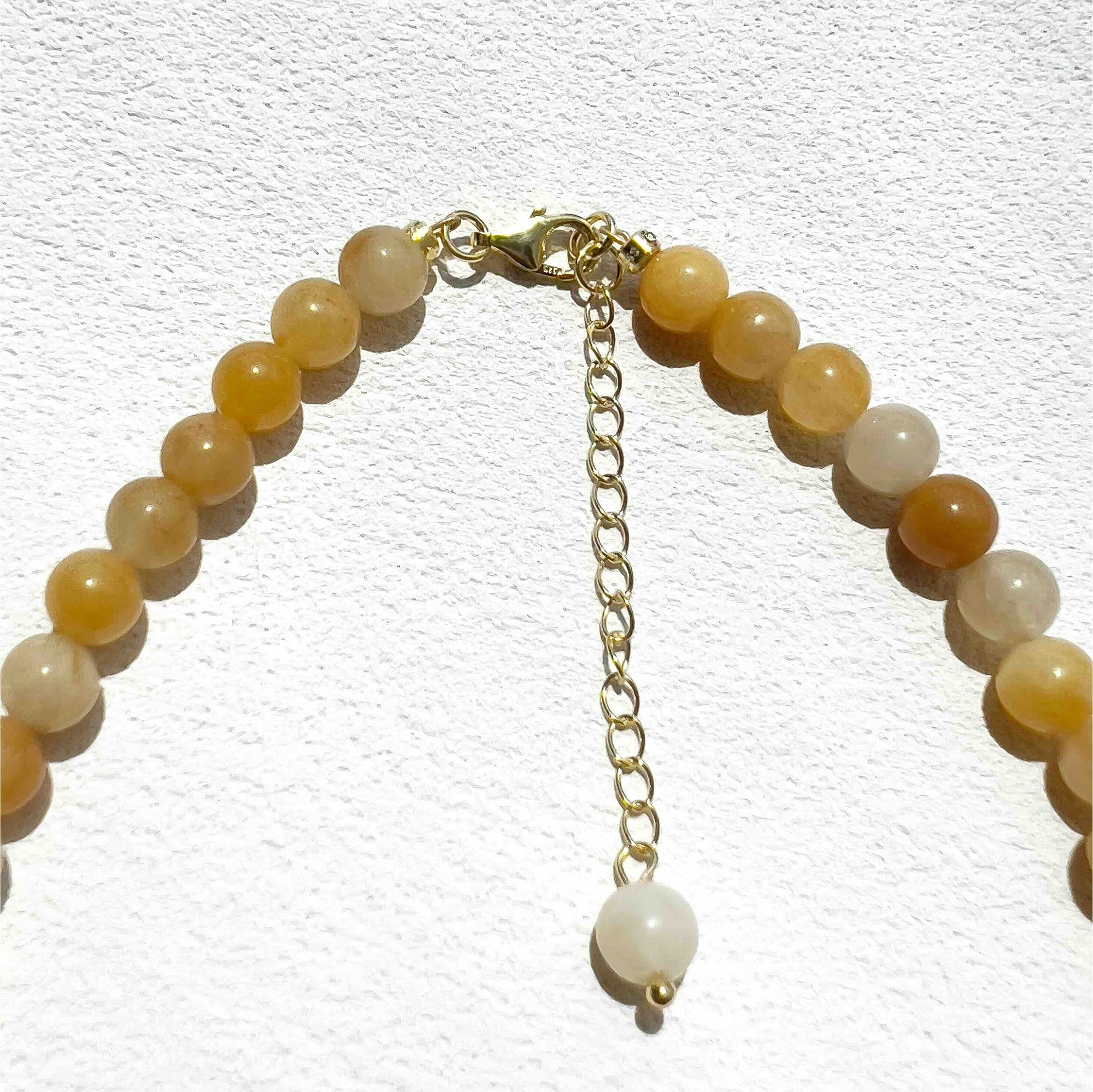 Close-up of the Yellow Aventurine Freya Necklace featuring soft yellow 6mm gemstone beads, subtle gold accents, and freshwater pearls, highlighting its warm, uplifting energy and delicate craftsmanship.
