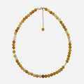 Yellow Aventurine crystal necklace with freshwater pearls and gold accents on a white background. Handmade 6mm gemstone beaded jewelry for confidence and warmth.